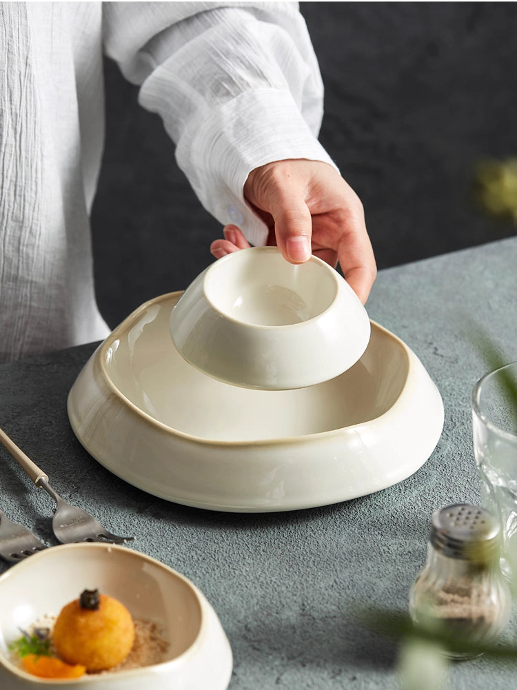 Ceramic deep plate with irregular shape for artistic food display