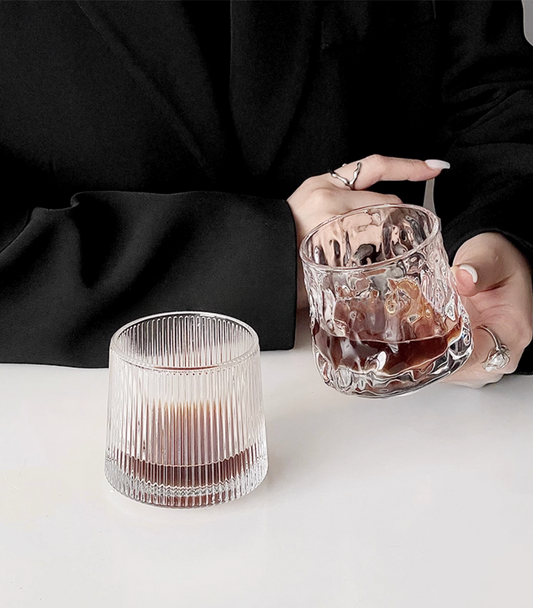 Hand holding Simple Palette Drinking Glass – Grid, demonstrating ergonomic design and comfortable grip.