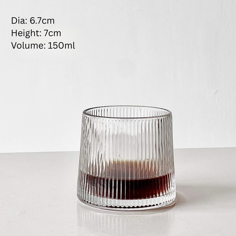 ifestyle shot of Simple Palette Ribbed Drinking Glass styled with iced coffee and greenery