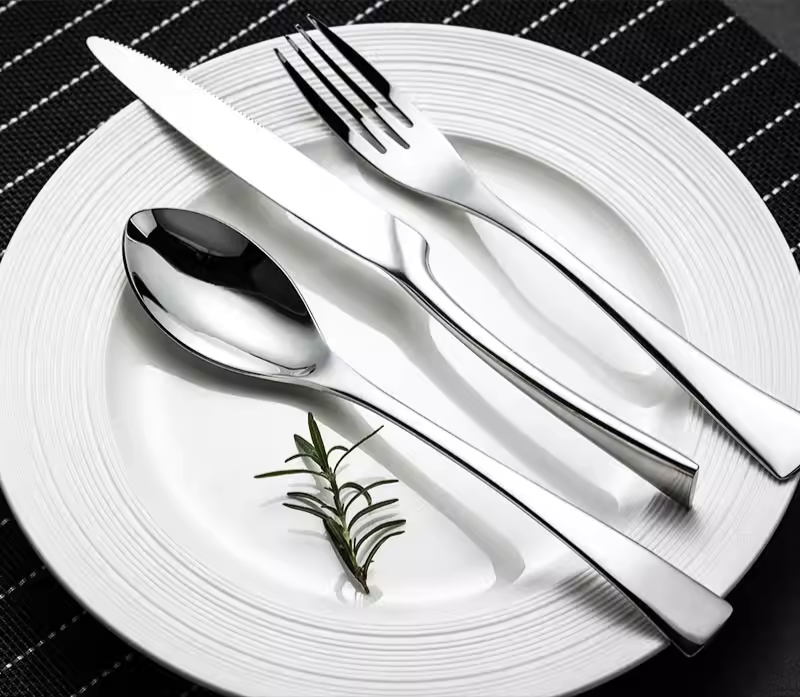Stainless steel cutlery from side angle showing handle ergonomics - handcrafted flatware