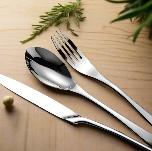 Close-up stainless steel knife and fork showing quality construction - artisanal flatware