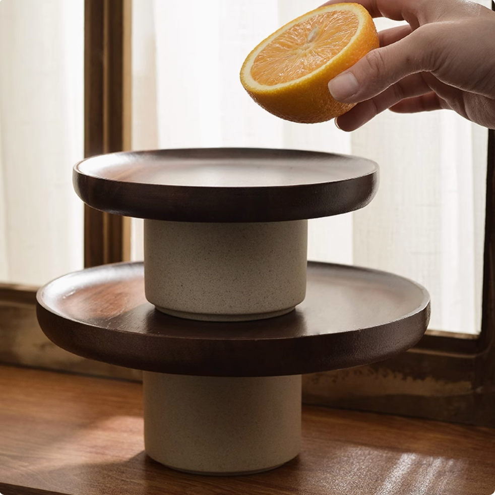 Stacking wooden serving platter stand styled with artisanal dinnerware for modern dining experience